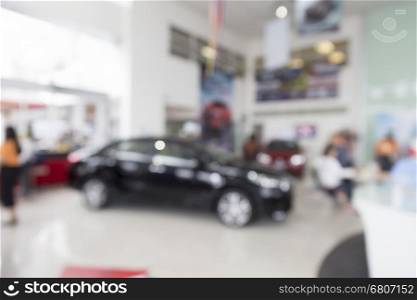 people in car showroom for buyring and selling car business concept, blur background