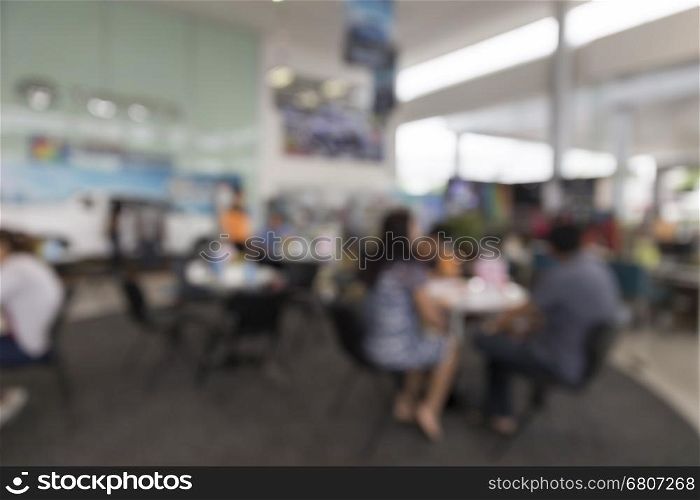 people in car showroom for buyring and selling car business concept, blur background
