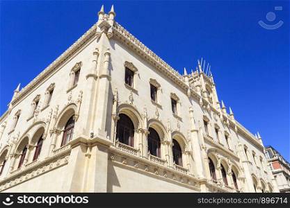 People in front of the Neo-Manueline style facade of Rossio railway station in the central historic area of Lisbon, Portugal