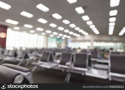 people in interior airport terminal building, blur background