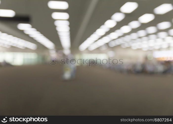 people in interior airport terminal building, blur background