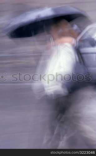 People in Motion with Umbrellas