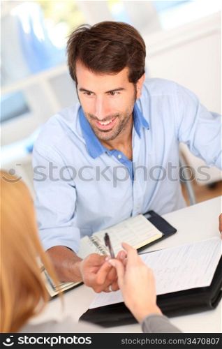 People in office signing contract