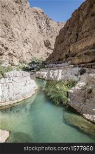 People in the canyon of the famous and touristic Wadi Shab, Tiwi, Sultanate of Oman, Middle East. River of Wadi shab, Oman