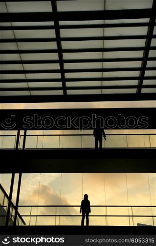people in the modern buildind at sunset