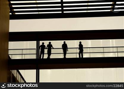 people inside the modern building, students in silhouette