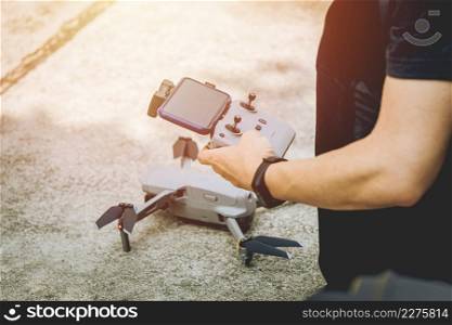 people learning to use smart drone for aerial photography