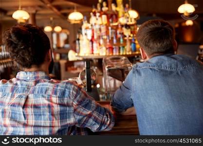 people, leisure and friendship concept - close up of male friends at bar counter in pub