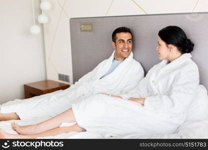 people, leisure and vacation concept - happy couple in bed at home or hotel room. happy couple in bed at home or hotel room