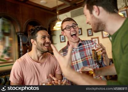 people, leisure, friendship and entertainment concept - happy football fans or male friends drinking beer and celebrating victory at bar or pub