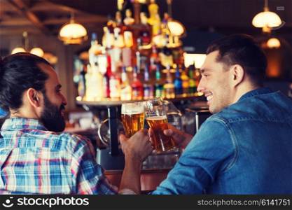 people, leisure, friendship, communication and bachelor party concept - happy male friends drinking beer and talking at bar or pub from back