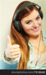People leisure relax concept. Closeup happy woman big headphones listening music mp3 relaxing making thumb up hand gesture