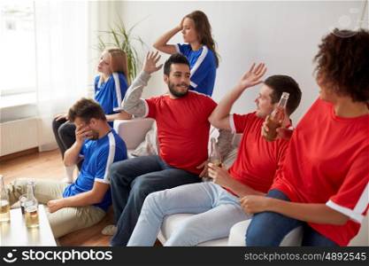 people, leisure, rivalry and sport concept - happy and sad friends or football fans drinking beer and watching soccer game or match at home
