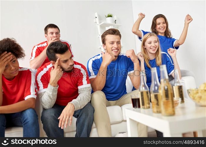people, leisure, rivalry and sport concept - happy friends or football fans drinking beer and watching soccer game or match at home