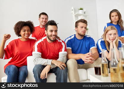 people, leisure, rivalry and sport concept - happy friends or football fans drinking beer and watching soccer game or match at home. friends or football fans watching soccer at home