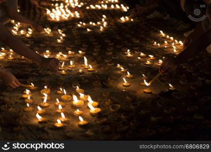 People light candle to pay respect to buddha relic at buddhist temple