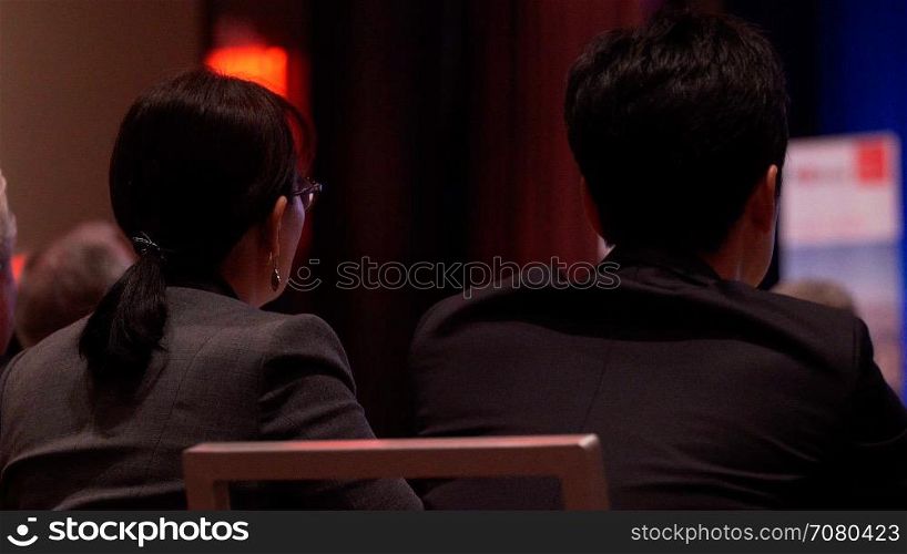 People listen intently at a conference