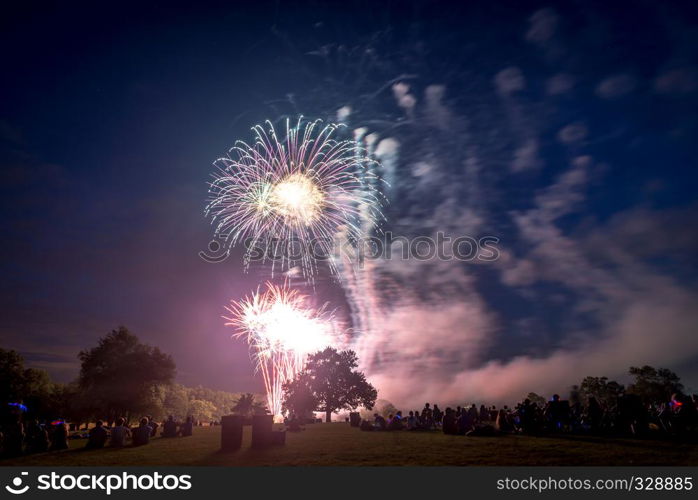 People looking at fireworks in honor of Independence Day. Fireworks on Independence day in USA