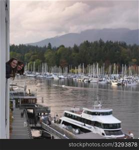 People looking at the boarts in the marina in Vancouver, British Columbia, Canada