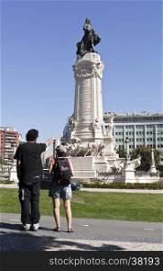People looking at the monument to the Marquis of Pombal in Lisbon, Portugal