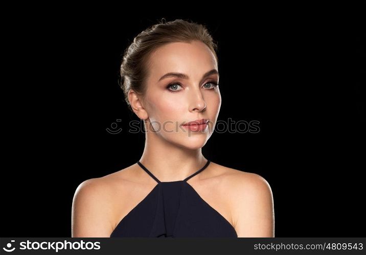 people, luxury and fashion concept - beautiful woman in black over dark background