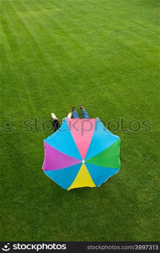 People lying under a parasol