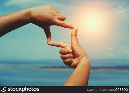 people make hand framing looking distant view sunrise. business concept