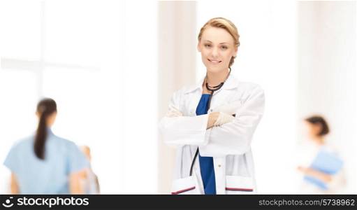 people, medicine and profession concept - smiling young female doctor over clinic background