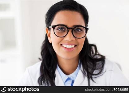 people, medicine, healthcare and facial expression concept - face of happy smiling young doctor or woman in glasses. face of happy smiling young doctor in glasses