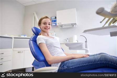 people, medicine, stomatology, dentistry and health care concept - happy patient girl at dental clinic office