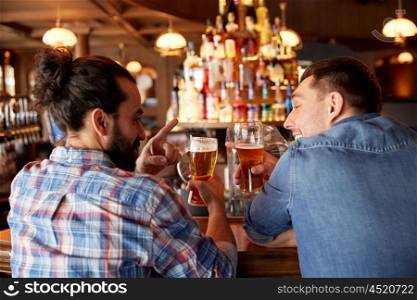 people, men, leisure, friendship and communication concept - close up of happy male friends drinking draft beer at bar or pub