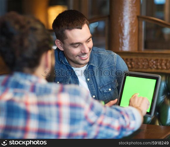 people, men, leisure, friendship and technology concept - happy male friends with tablet pc computer at bar or pub