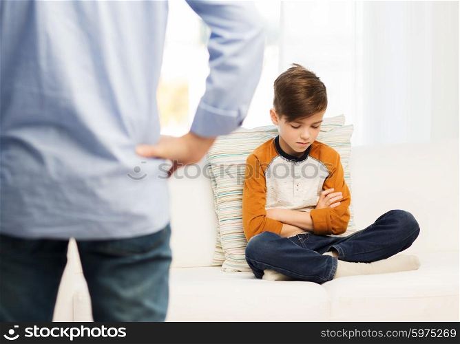 people, misbehavior, family and relations concept - close up of upset or feeling guilty boy and father at home