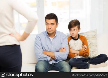 people, misbehavior, family and relations concept - upset feeling guilty or displeased father, son and angry mother at home
