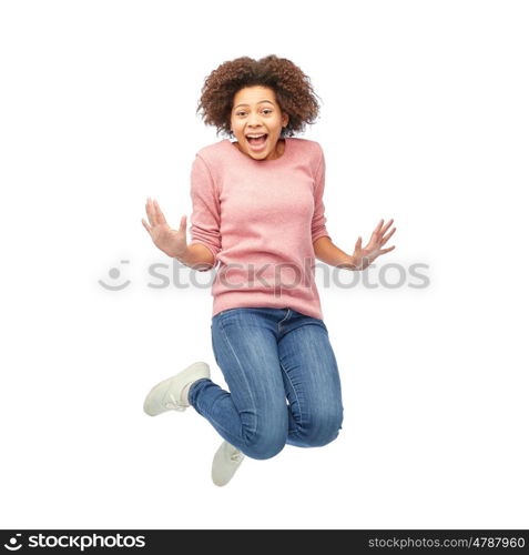 people, motion and action concept - happy african american young woman jumping over white
