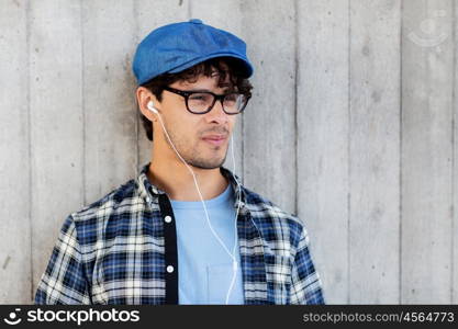 people, music, leisure and lifestyle - man with earphones listening to music on street