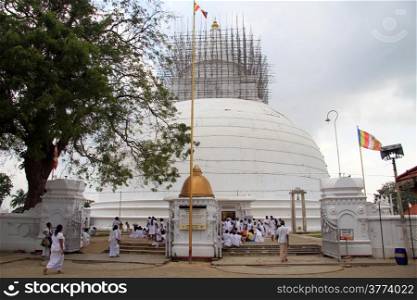 People near big white stupa in Tissa, Sri Lanka