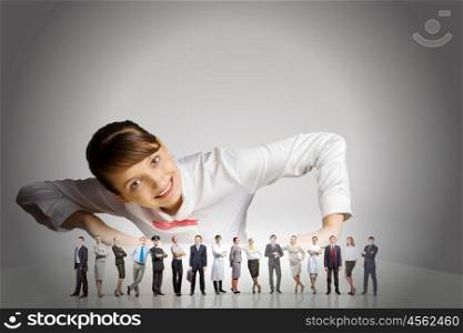 People of different professions. Businesswoman leaning on table and looking at businessteam