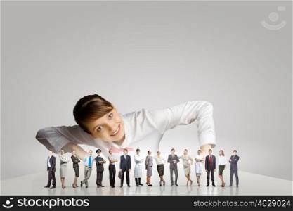 People of different professions. Businesswoman leaning on table and looking at businessteam