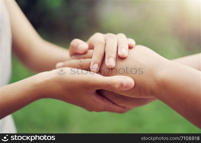 people old and young hand holding with sunlight. concept power of hope