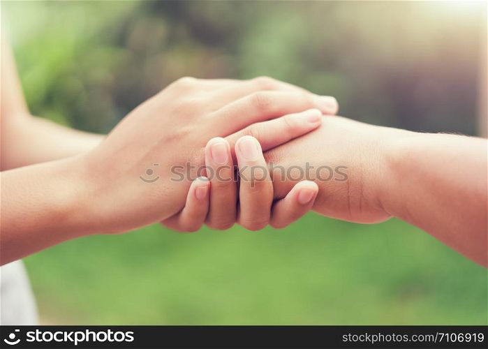 people old and young hand holding with sunlight. concept power of hope