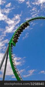 People on a green roller coaster ride.