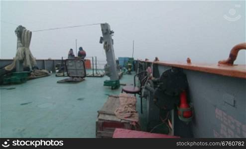 People on aft deck of commercial fishing boat