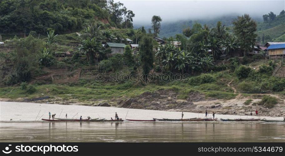 People on boats along shoreline, River Mekong, Sainyabuli Province, Laos