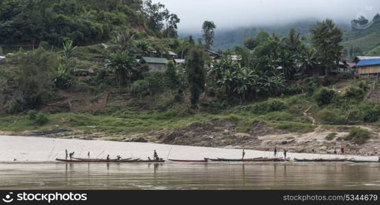 People on boats along shoreline, River Mekong, Sainyabuli Province, Laos