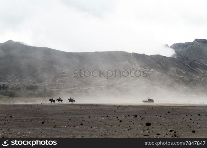 People on horses and pick up truck near volcano Bromo, Indonesia