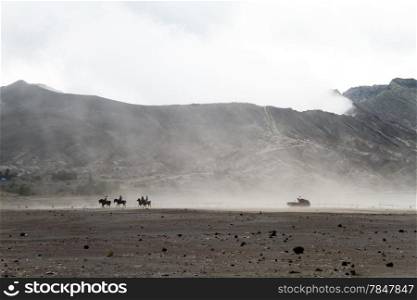 People on horses and pick up truck near volcano Bromo, Indonesia