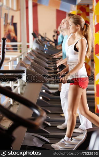 People on racetracks in fitness centre