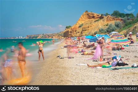 People on sea shore beach at sunny day. Long axposure composition.