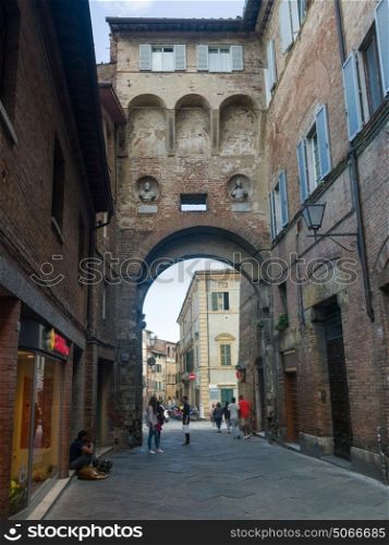 People on street amidst buildings, Siena, Tuscany, Italy